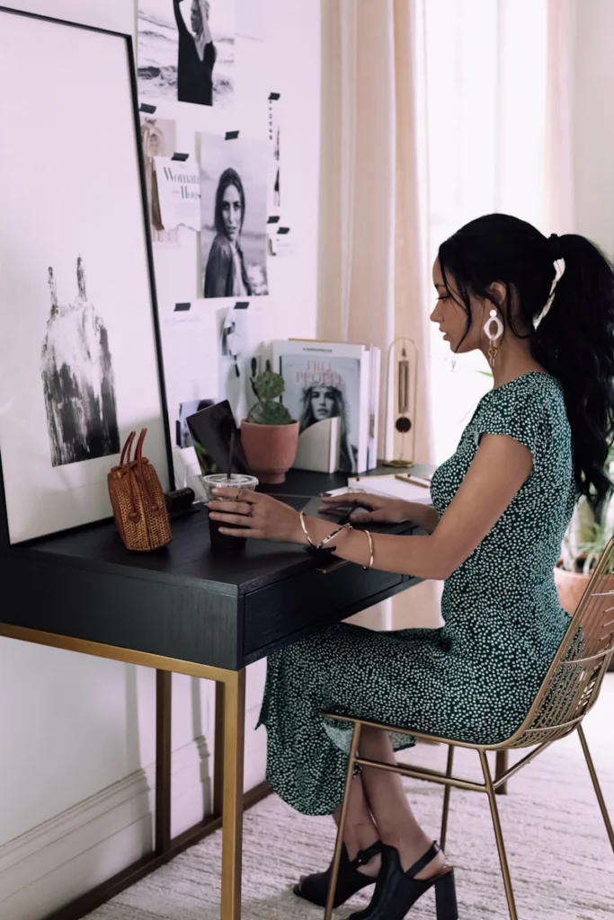 woman sitting beside table inside room
