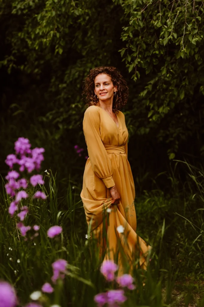 A woman standing in a field of purple flowers
