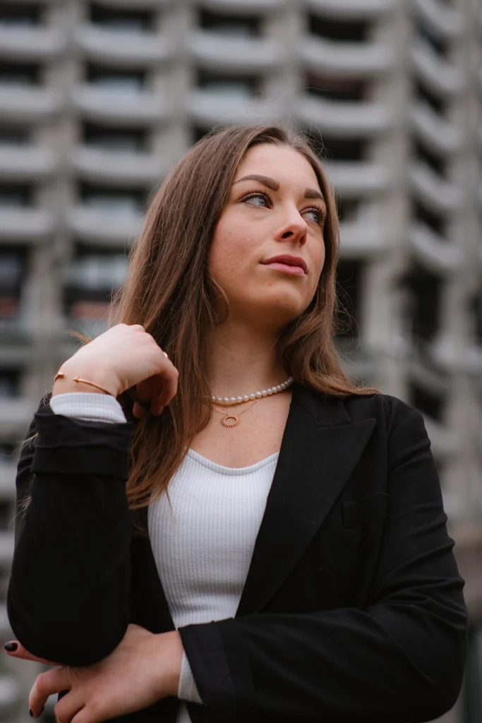 A woman standing in front of a tall building