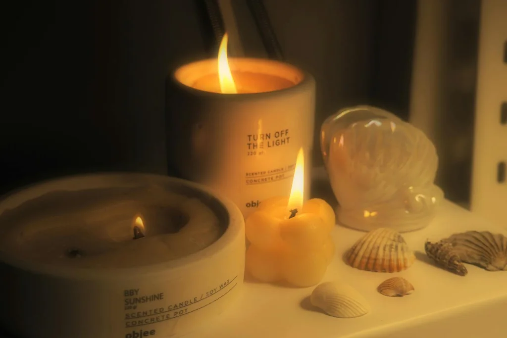 Warm candlelit arrangement with seashells and decor setting a cozy mood.