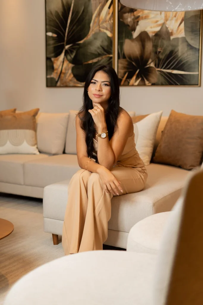 Stylish woman in chic living room with modern decor and neutral tones.