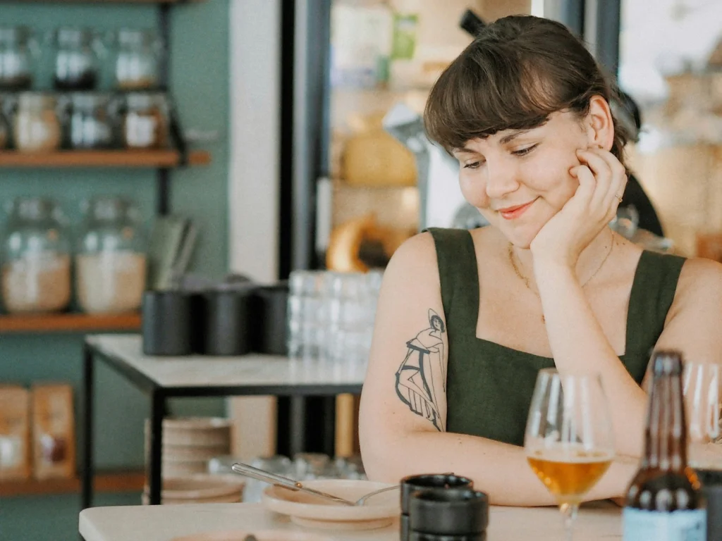 woman in black and white tank top sitting at table