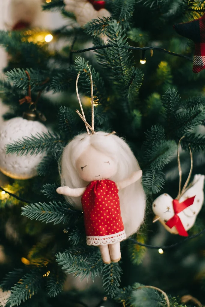 Charming Christmas tree adorned with a whimsical doll and festive ornaments.