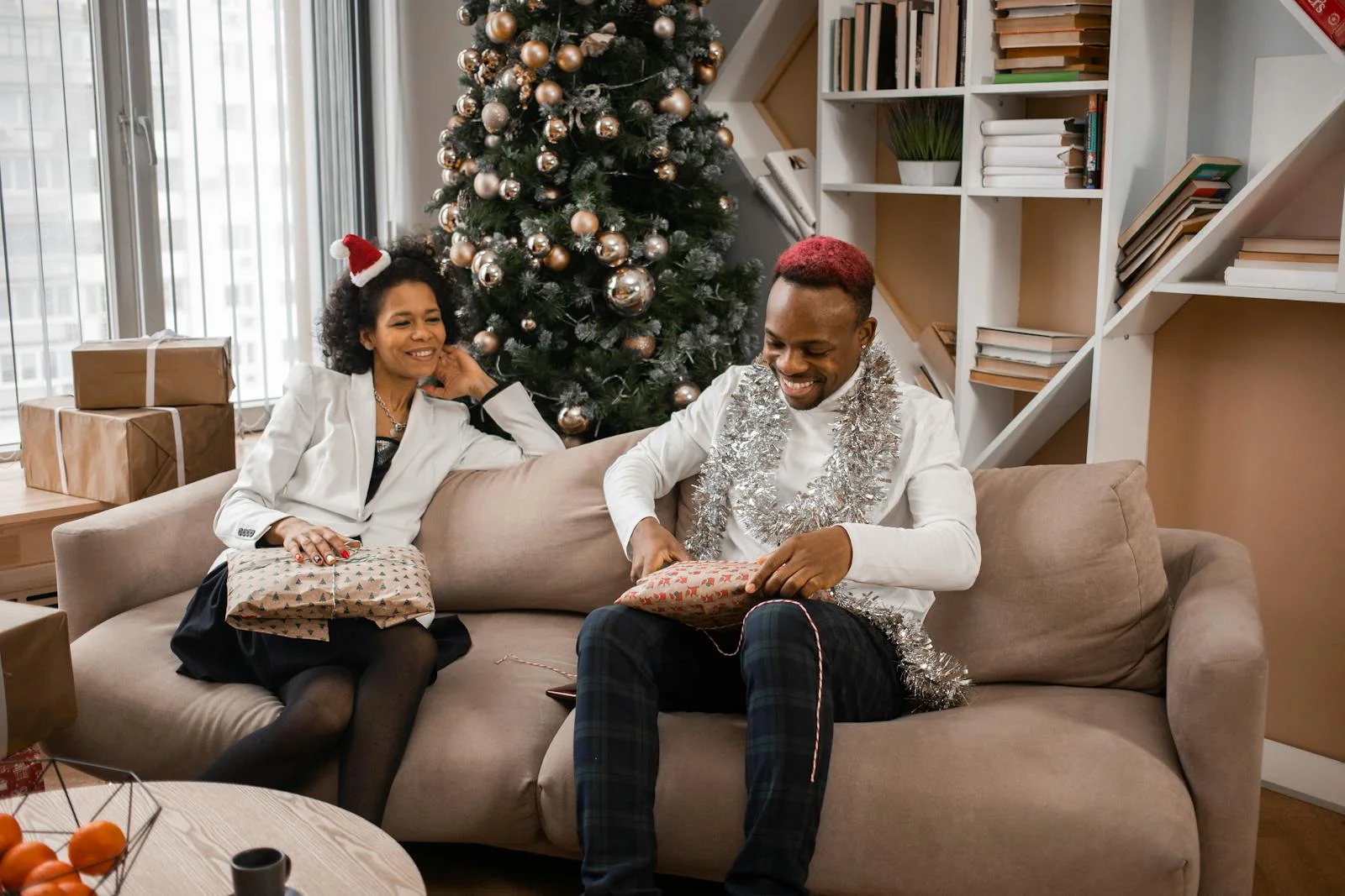 Happy family enjoying Christmas gift exchange in cozy living room.