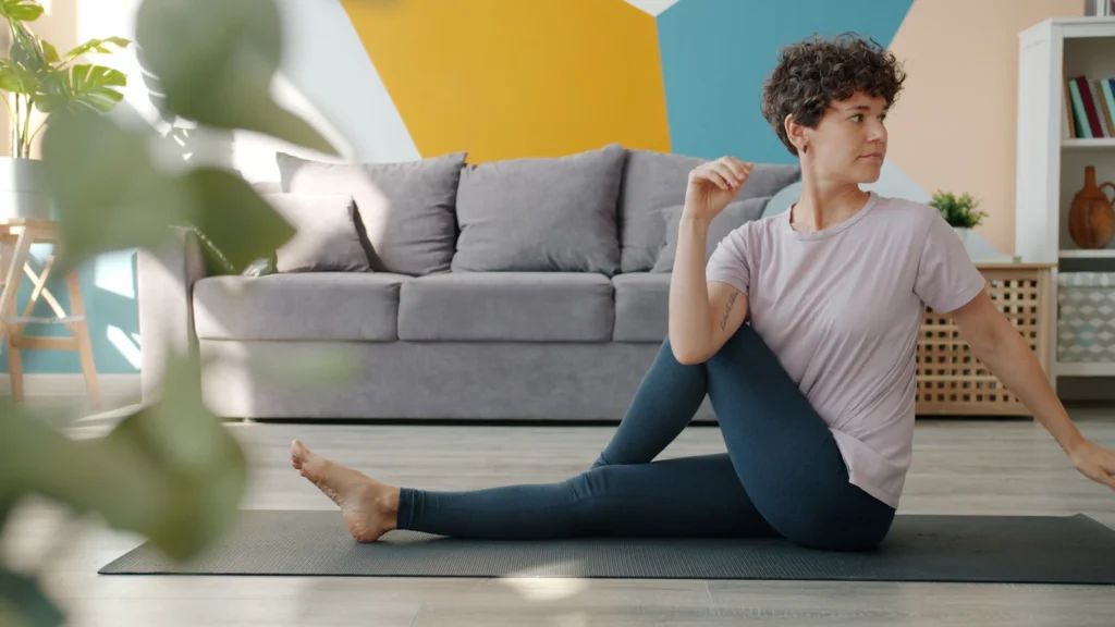 Woman doing a seated spinal twist yoga pose.