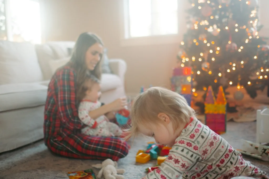 a woman and a baby playing with toys