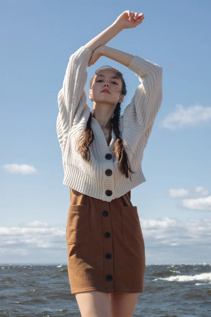 woman in white and brown striped button up shirt and brown pants