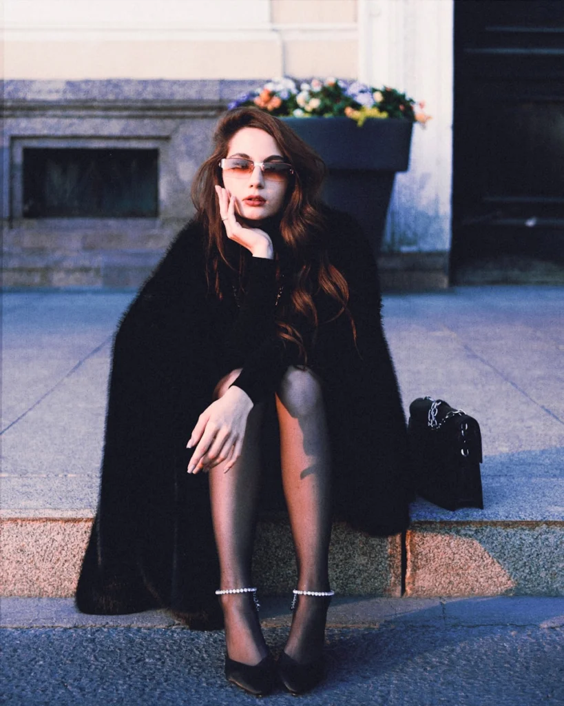 a woman sitting on a step talking on a cell phone