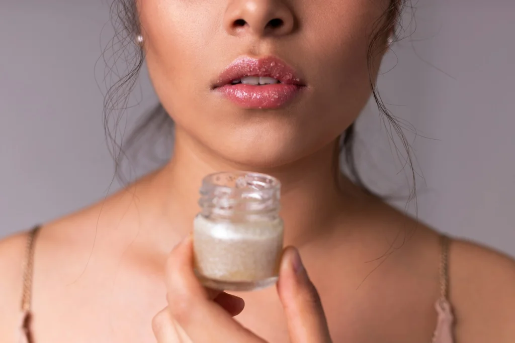 woman holding white plastic bottle