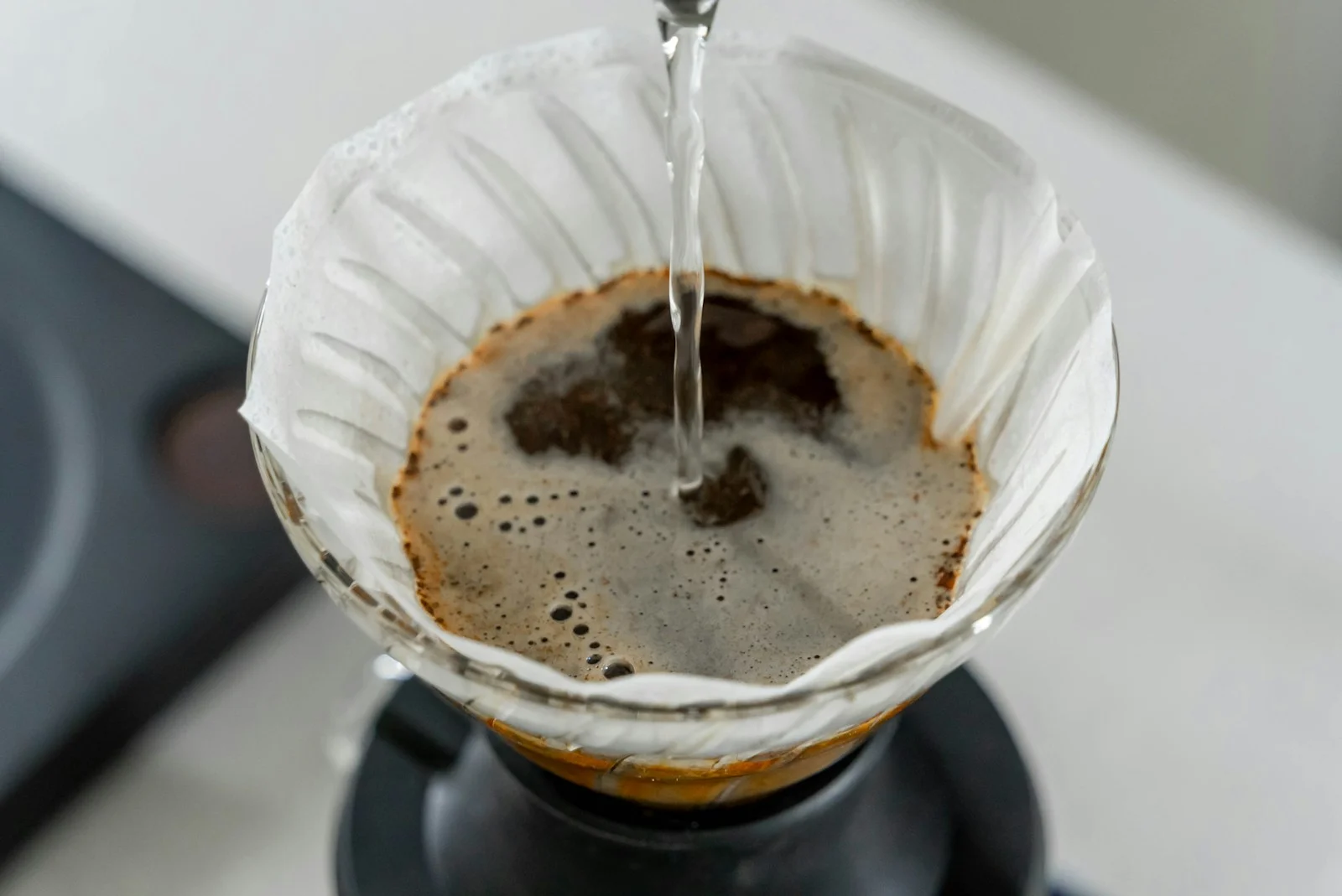 a coffee pot filled with liquid on top of a stove