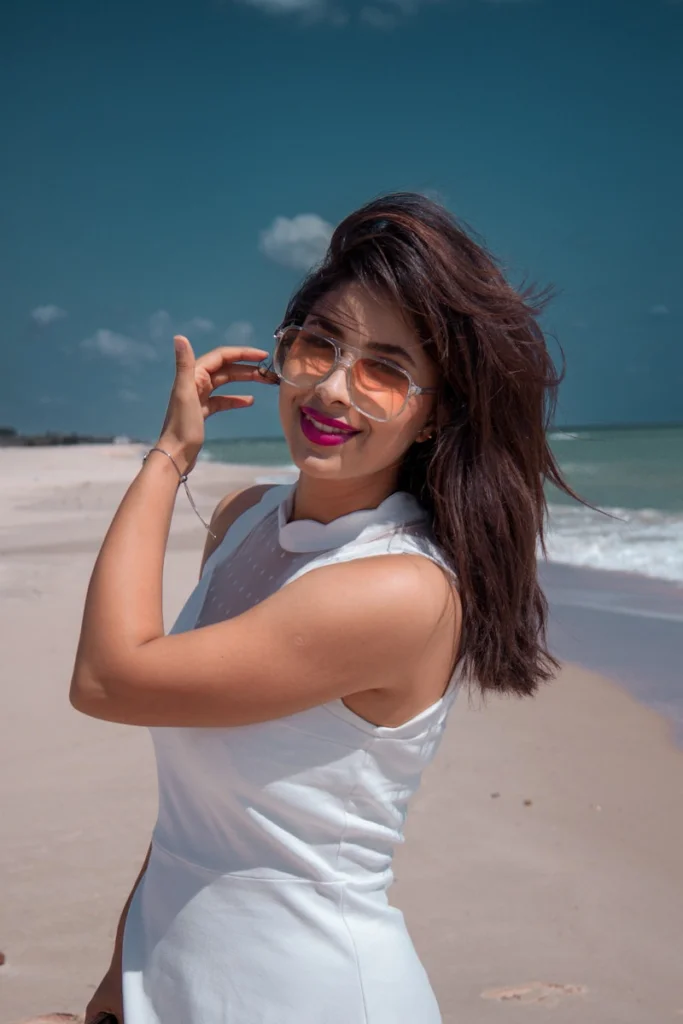 a woman in a white dress on the beach