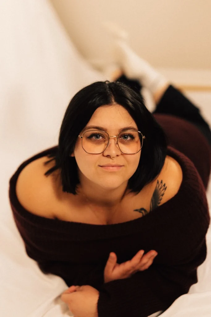 Young woman with glasses lying down