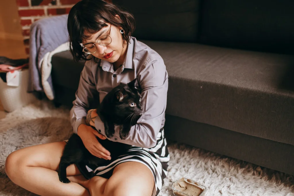 woman in black and white stripe shirt lying on brown couch