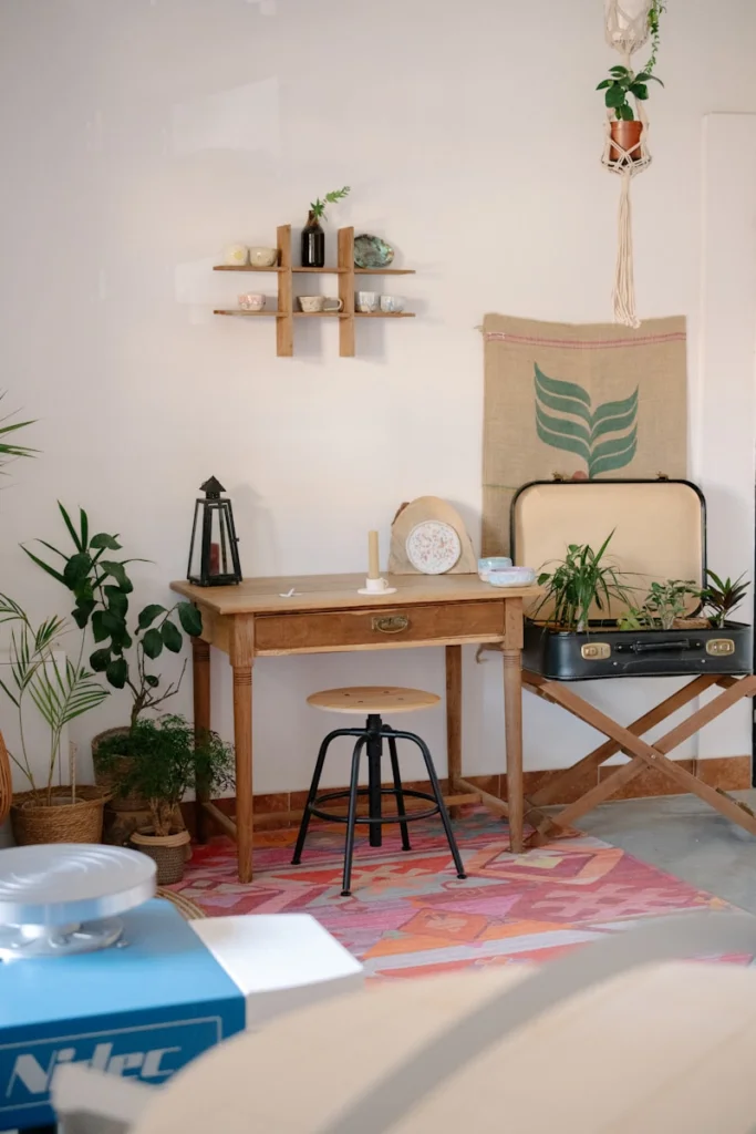 A cozy, bohemian workspace with plants and decor.