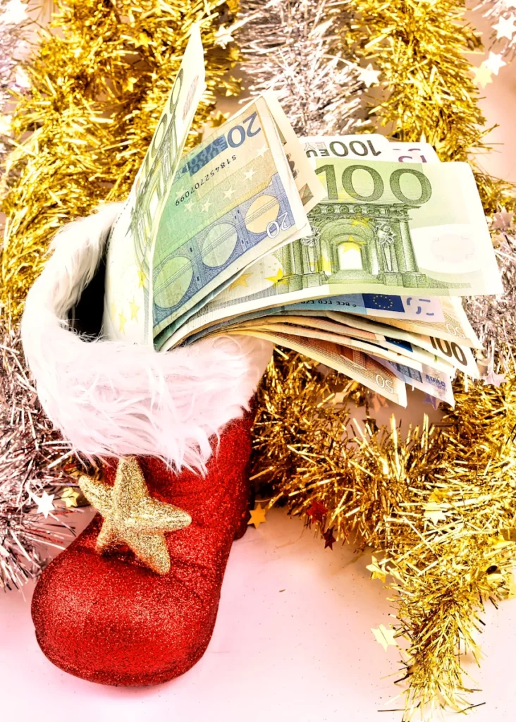 A christmas stocking with money sticking out of it