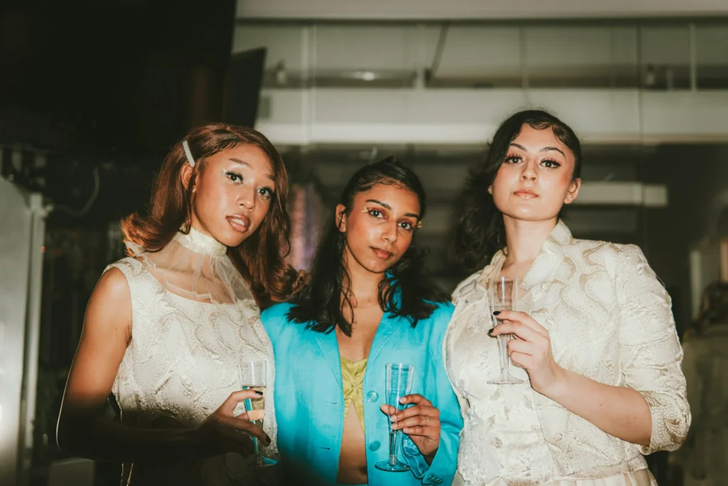 a group of three women standing next to each other