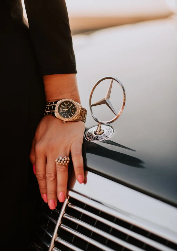 a close up of a person's hand on the hood of a car