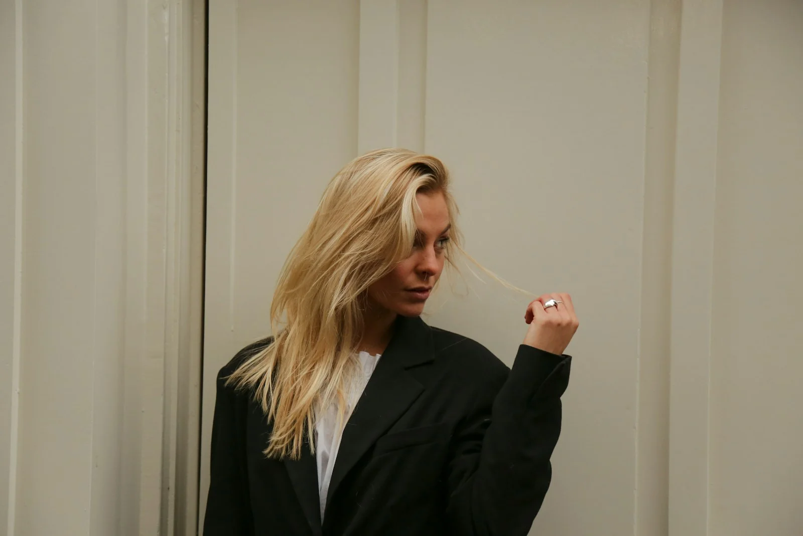 a woman brushing her hair in front of a mirror