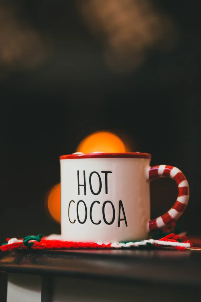 a red and white coffee cup sitting on top of a table