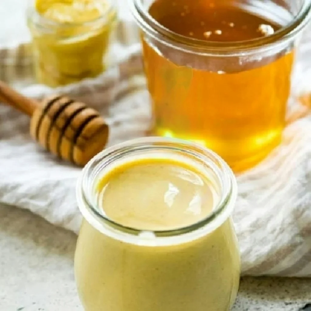 a jar of honey sits next to a jar of honey