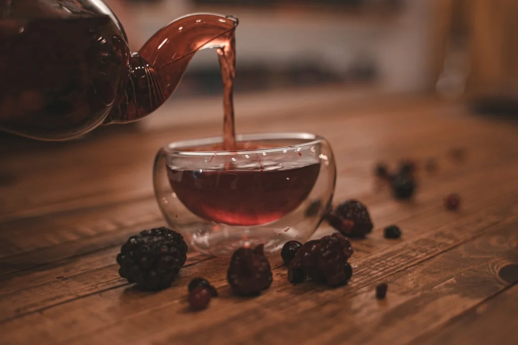 clear glass cup with brown liquid