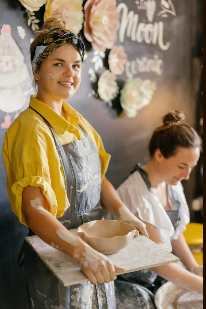 Women engaged in pottery making, showcasing handmade ceramics with artistic flair.