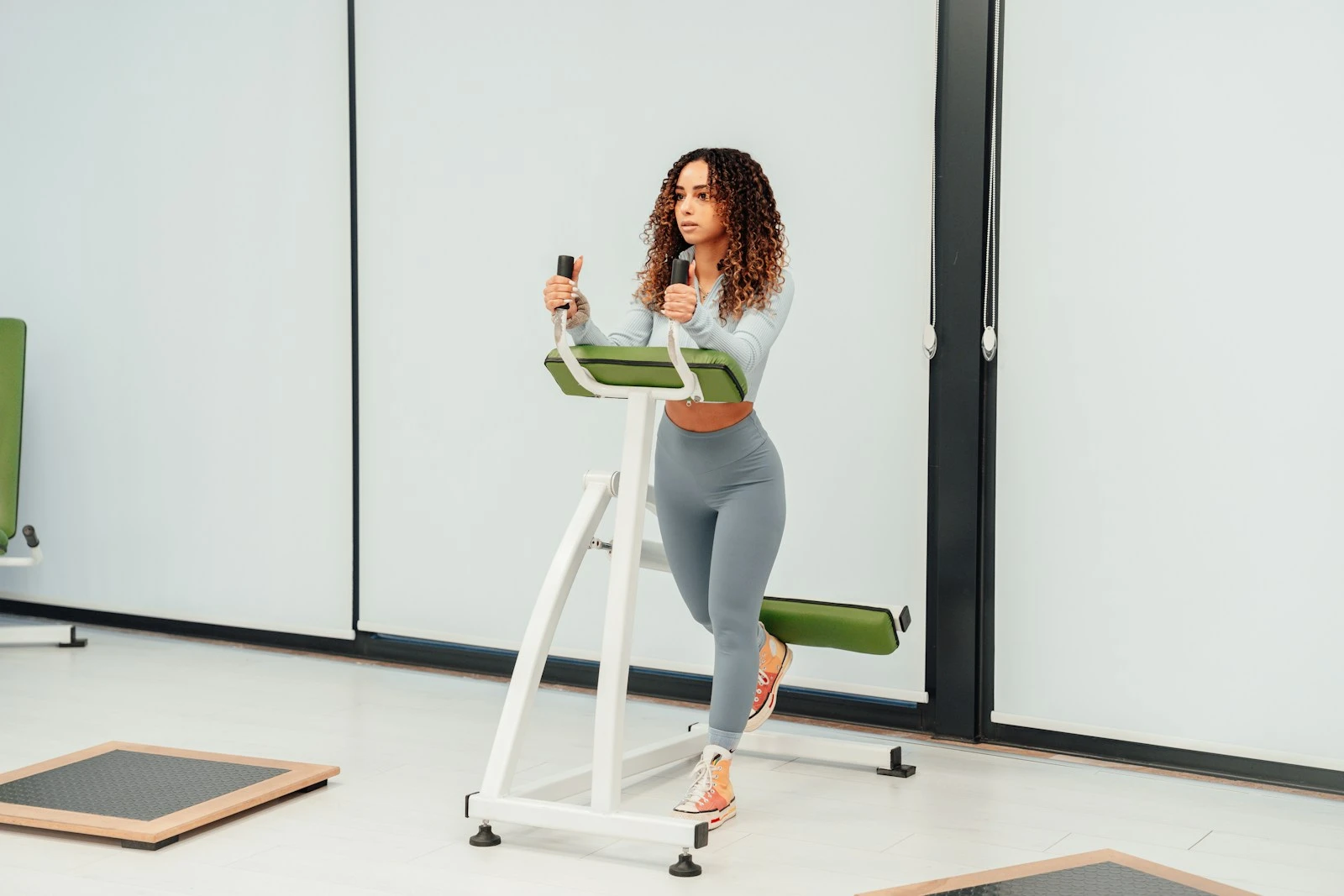 a woman using a treadmill in a room