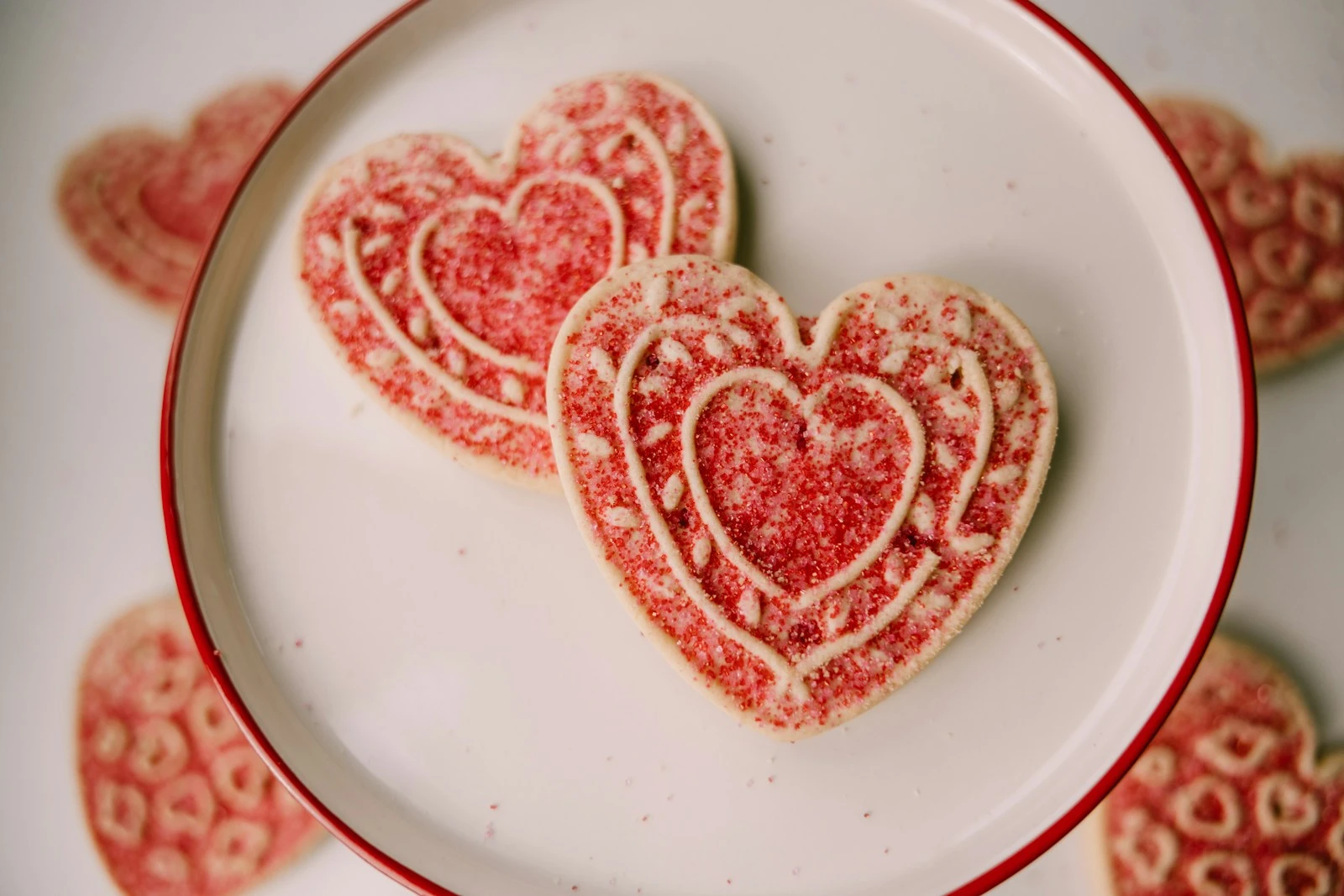 two heart shaped sugar cookies on a plate