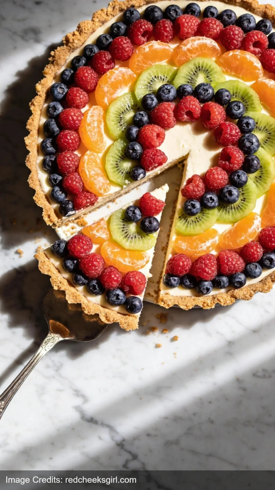 no-bake fruit tart with vanilla custard topped with arranged fresh berries and kiwi