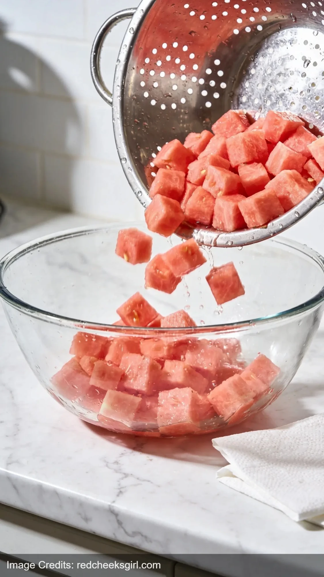 watermelon draining in colander to prevent soggy picnic salad