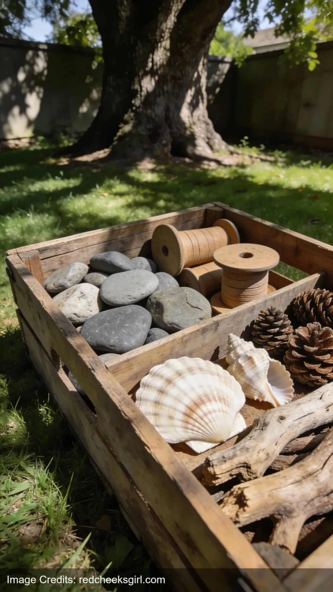 wooden crate filled with natural loose parts materials like rocks shells and wood for kids outdoor play