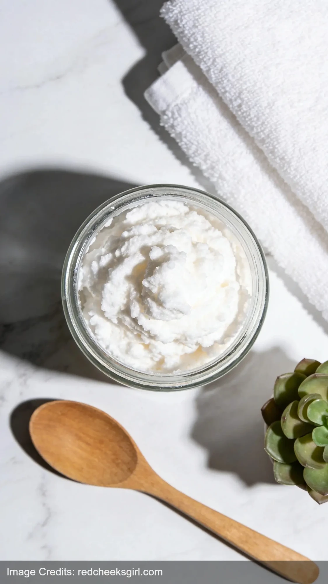 whipped soap in clear glass jar showing fluffy texture on marble countertop