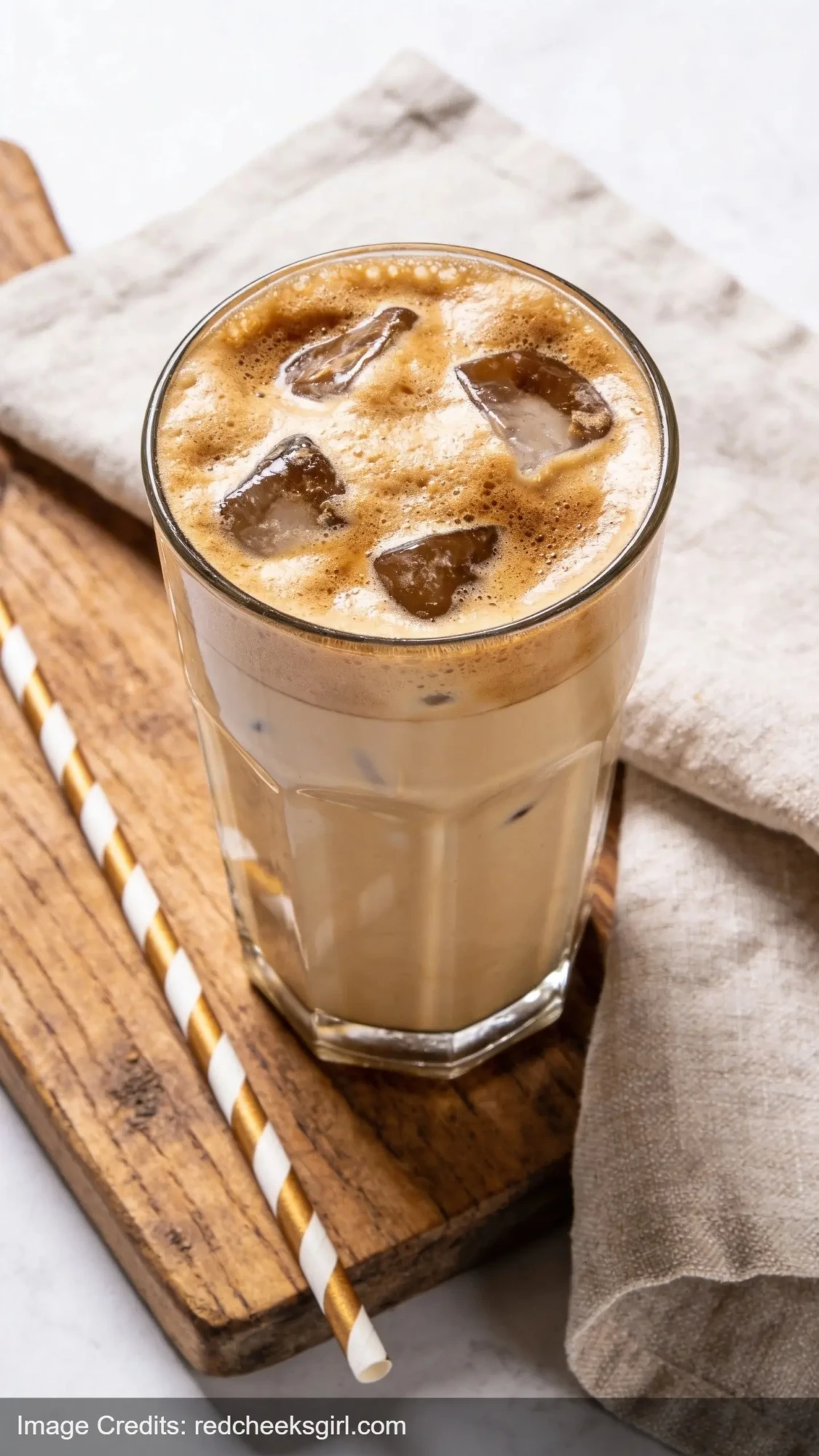 Greek frappe coffee with dense foam in tall glass