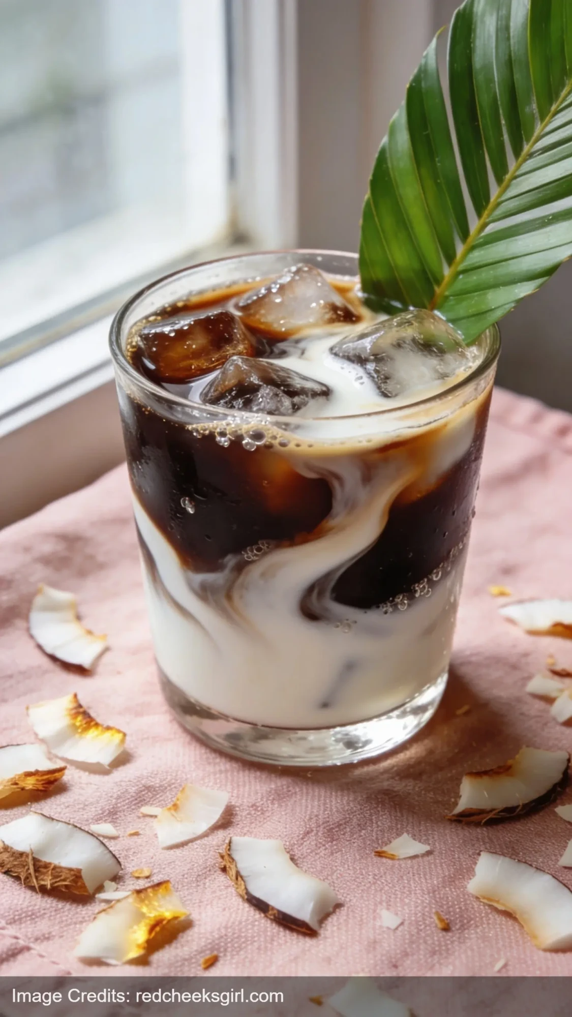 coconut iced coffee with coconut milk swirls and ice