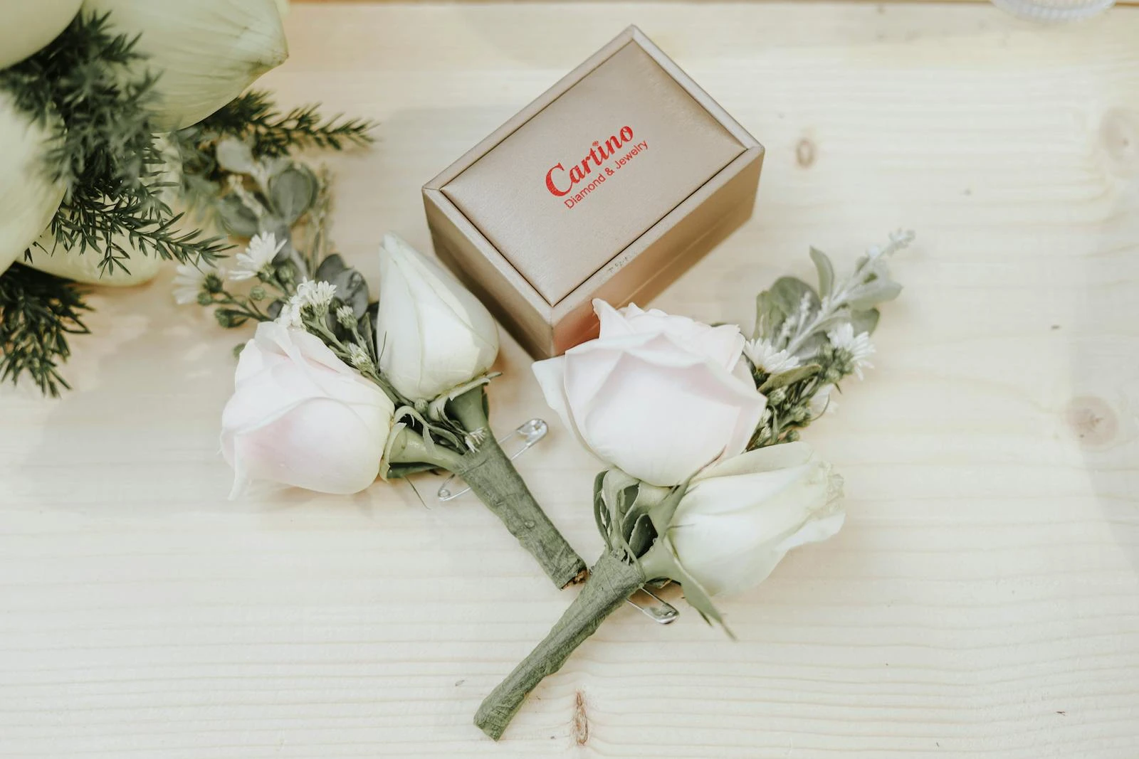 A jewelry box with beautiful roses on a white wooden background, perfect for romantic themes.