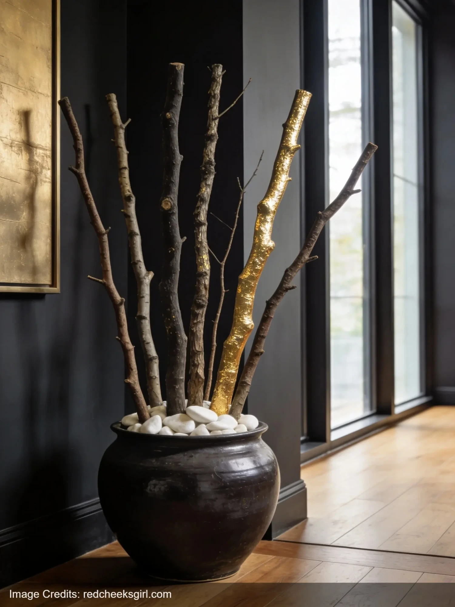 Large sculptural tree branch arrangement in dark vase looking like boutique decor