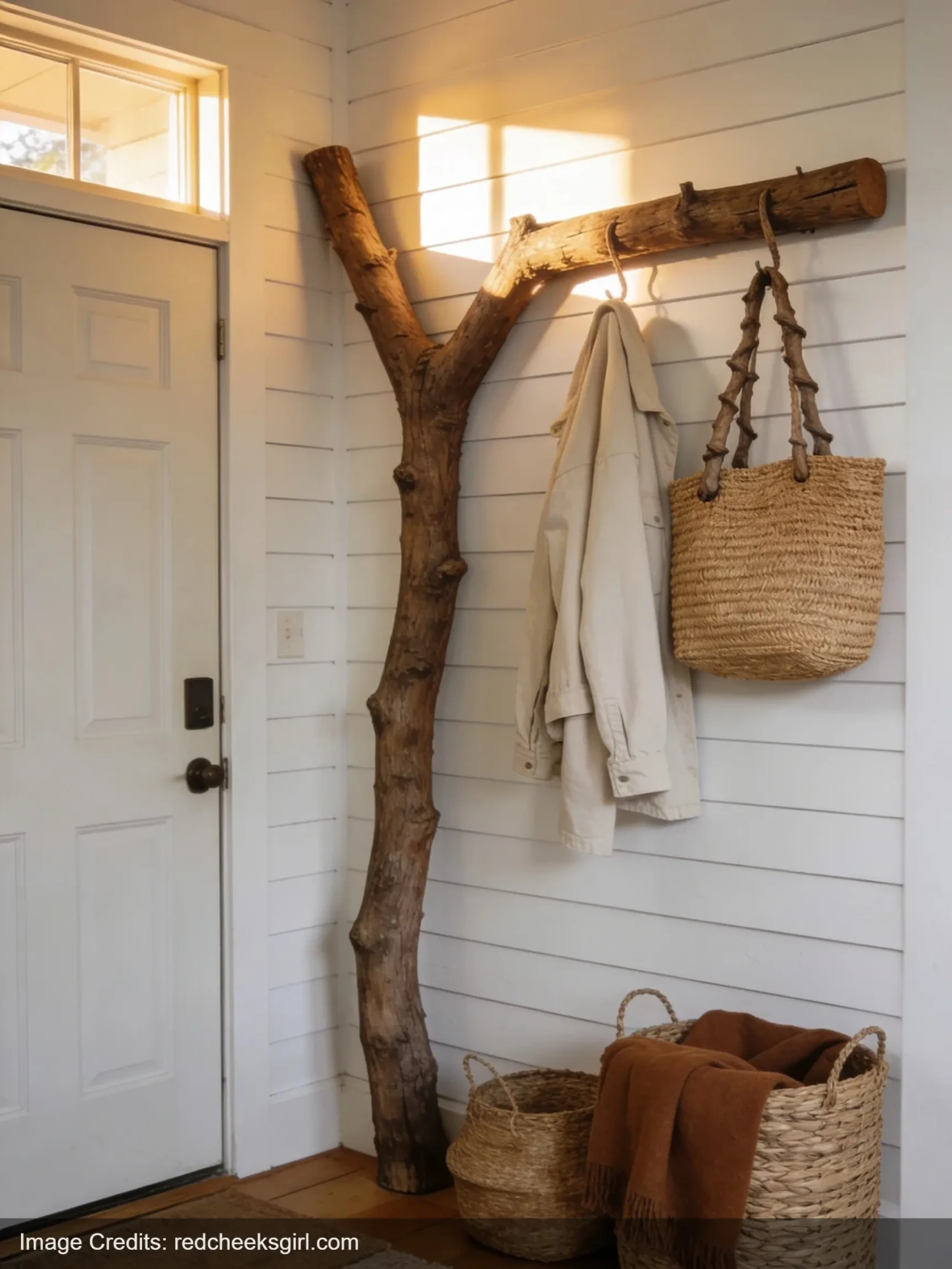 DIY tree branch coat rack in farmhouse entryway with bags and jackets