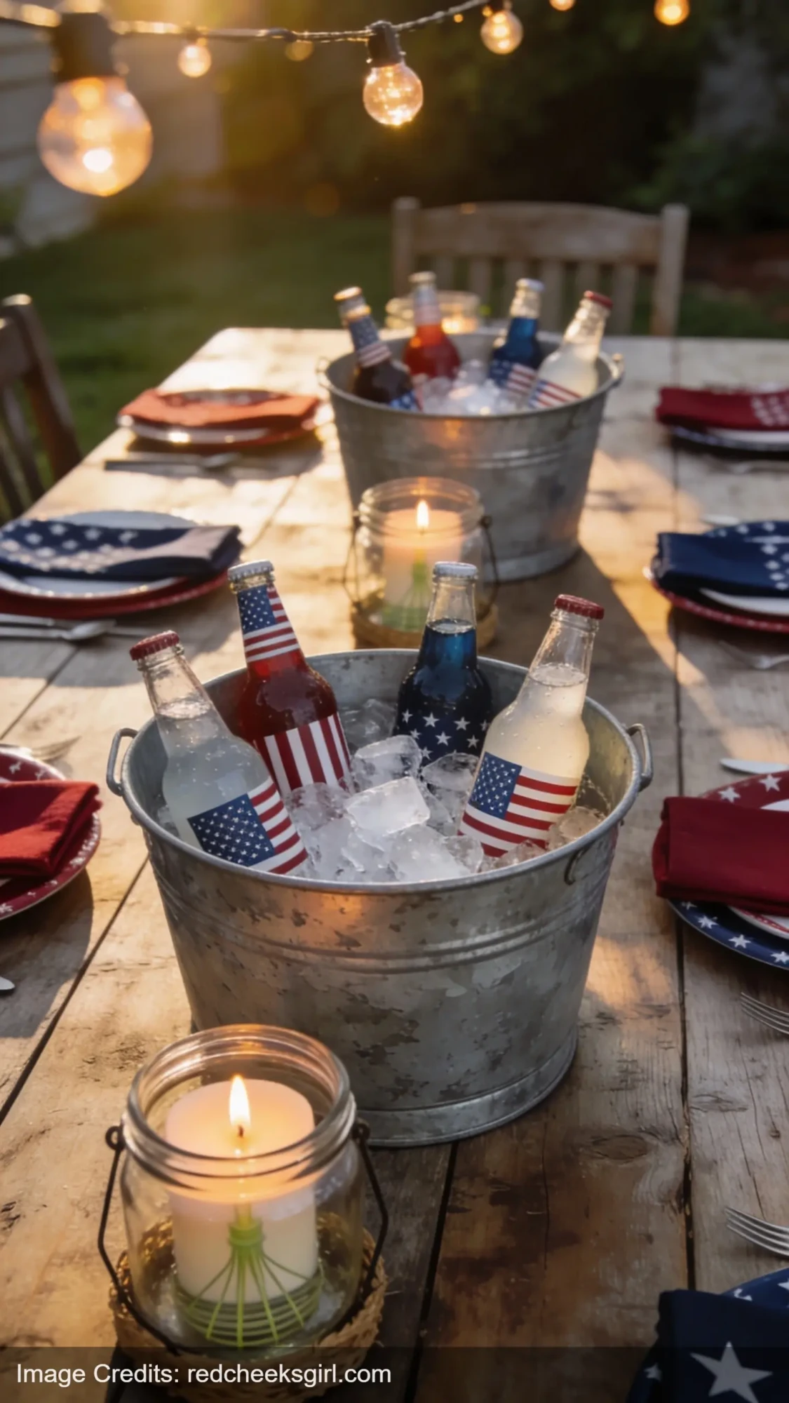 galvanized buckets with drinks and citronella candles on outdoor table for 4th of July party