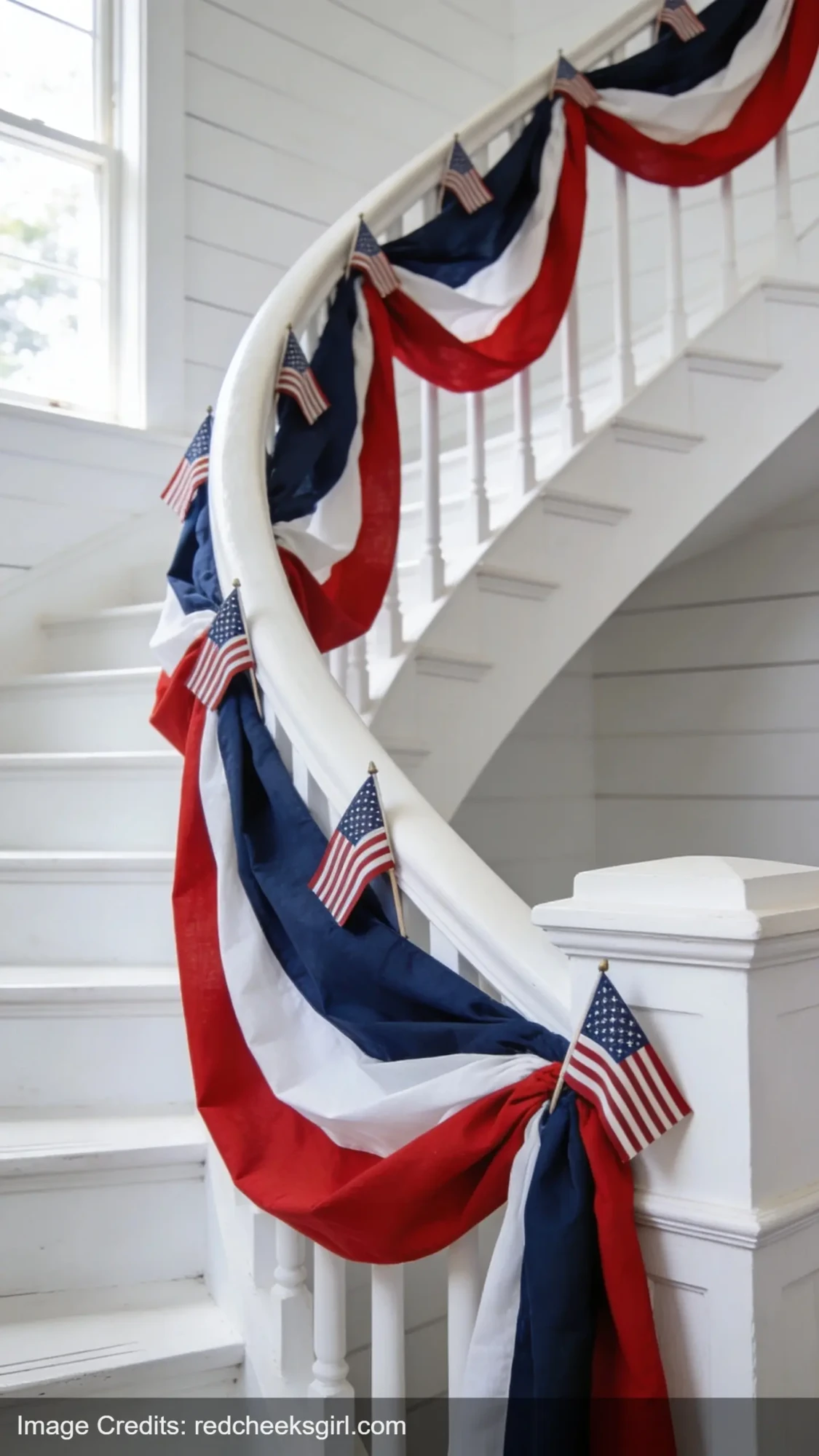 red white blue fabric garland draped on white staircase bannister for indoor 4th of July decor