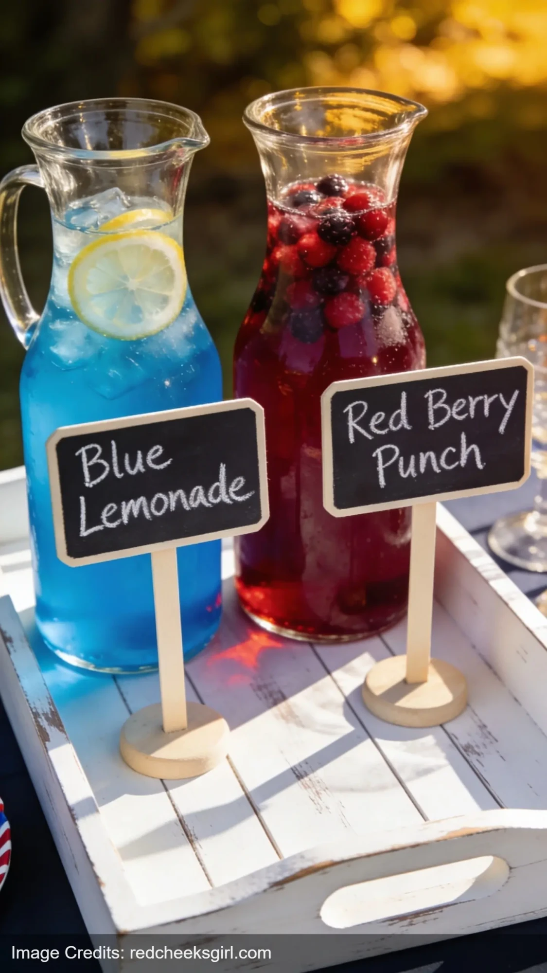 patriotic drinks in clear pitchers with chalkboard labels for 4th of July beverage station