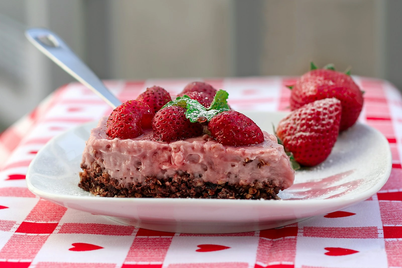a piece of cheesecake with strawberries on a plate