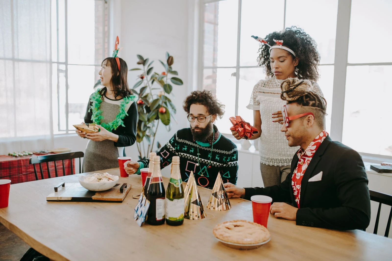 Diverse group of employees celebrating a holiday party in a bright office setting.