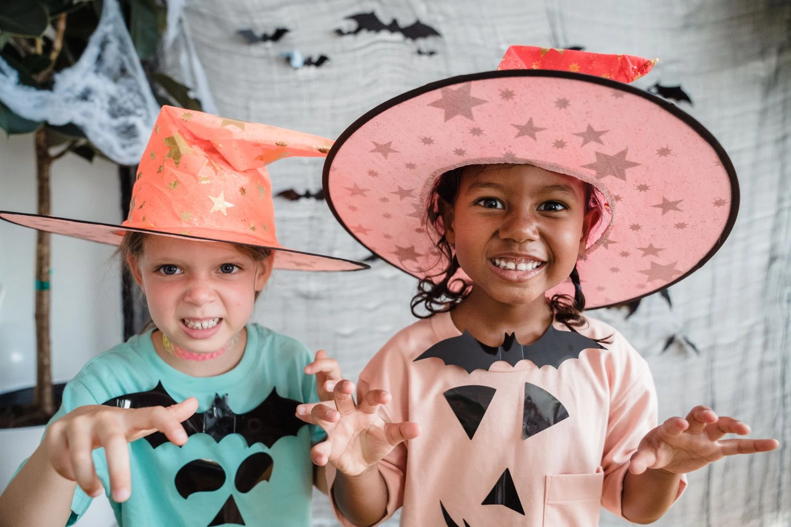 Children dressed in Halloween costumes having fun indoors, embodying spooky joy.