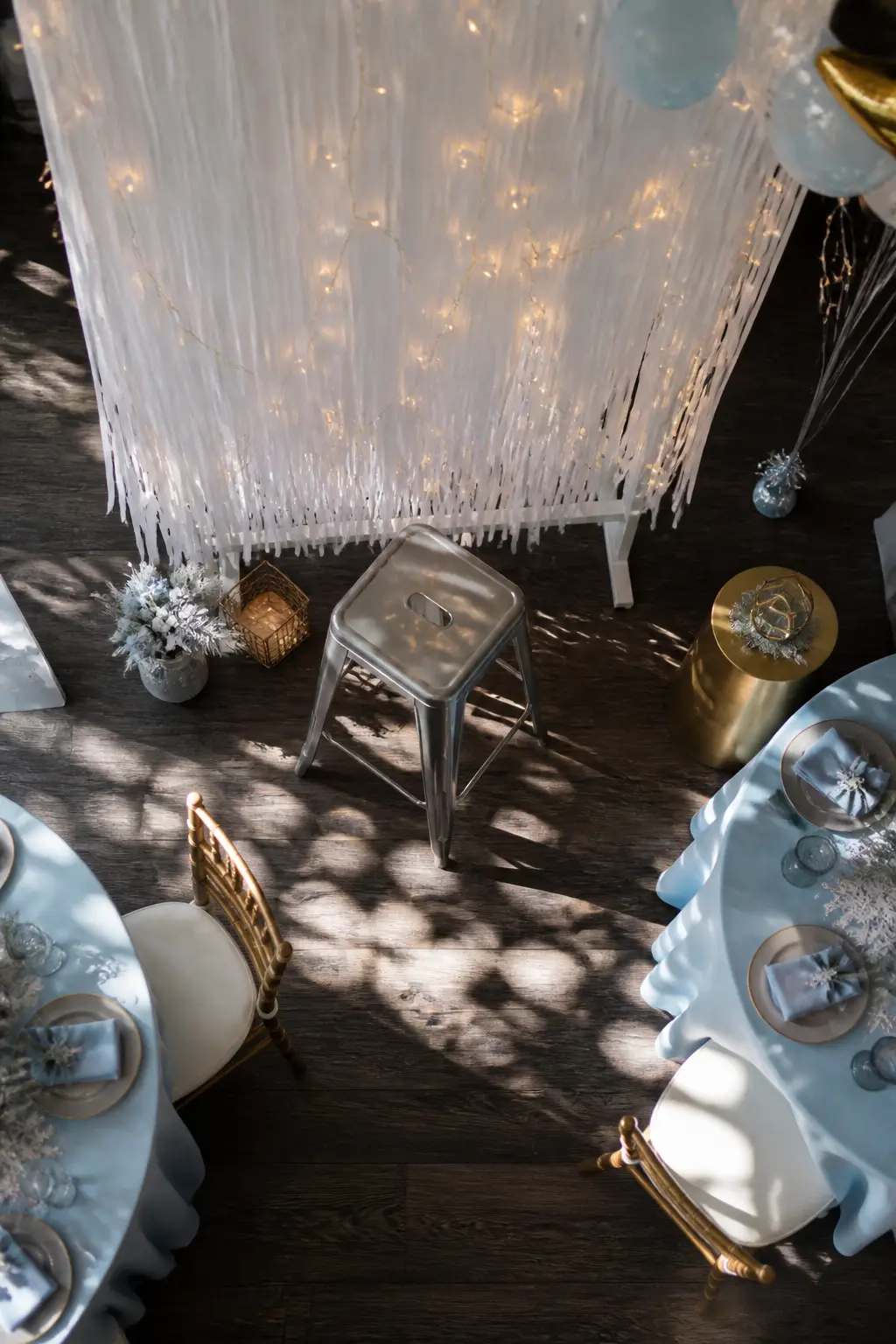 A Photo Corner With a White Fringe Curtain and Fairy Lights