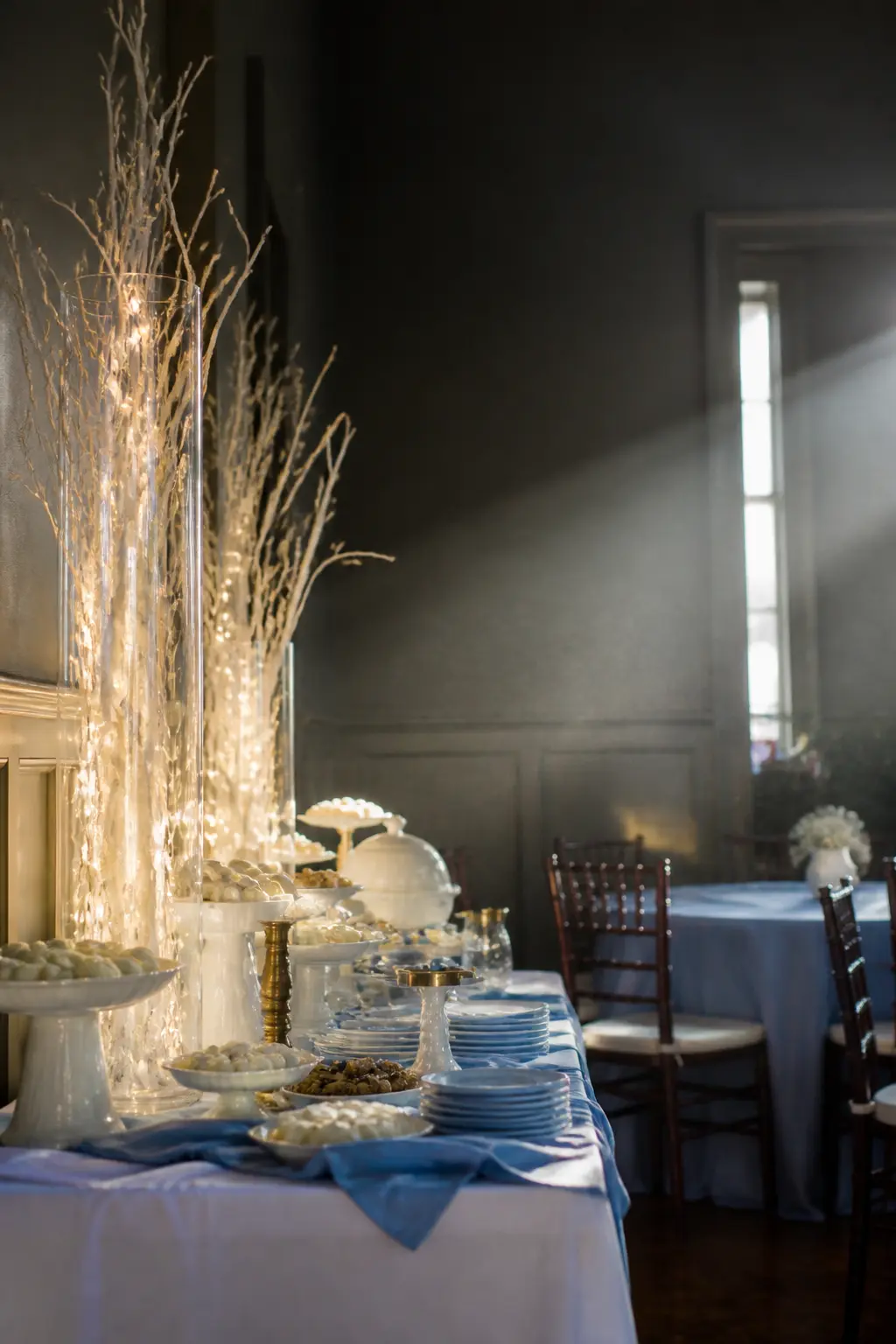 White Branches in Tall Vases With Fairy Lights Inside
