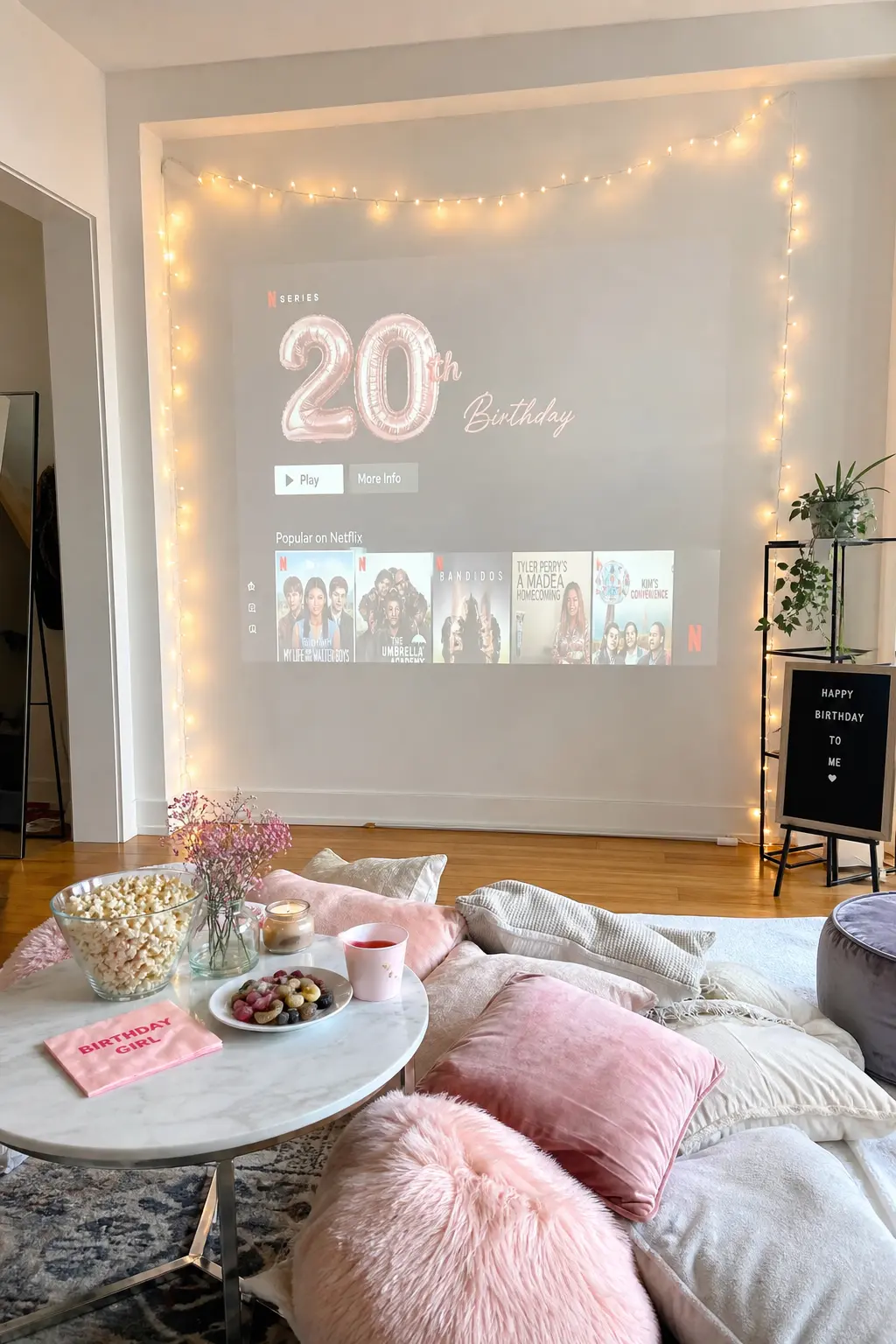 Living Room Movie Marathon Setup — A pile of floor cushions faces a blank wall used as a screen, framed by fairy lights, with a popcorn station set up nearby.