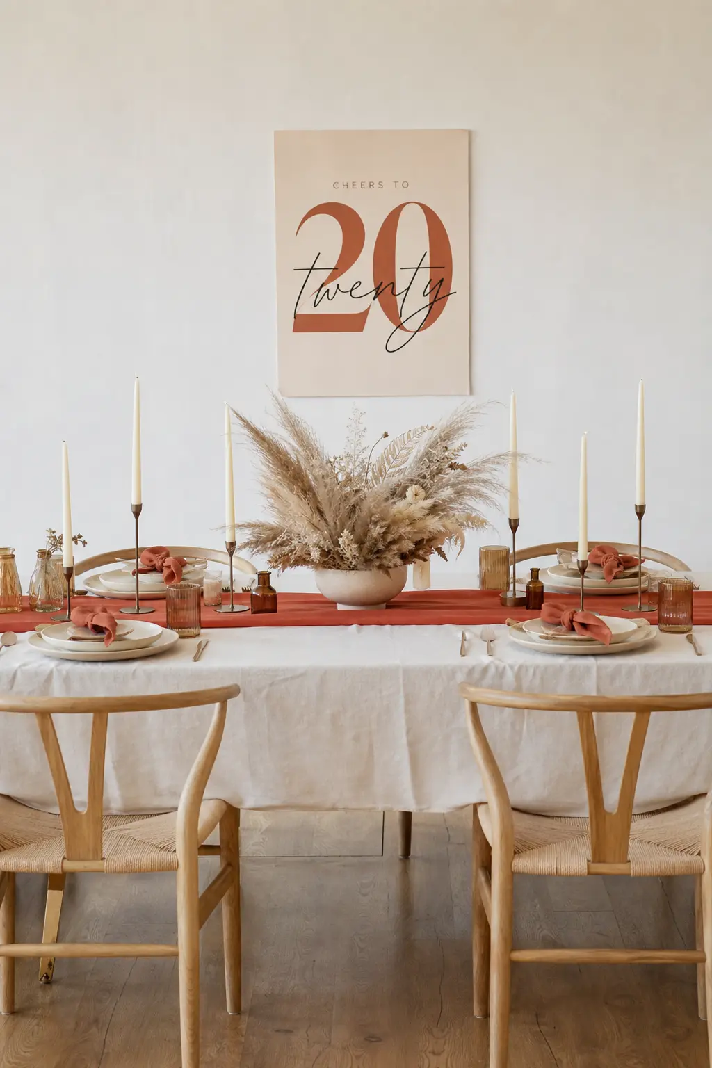 Terracotta and Cream Fall Table — A terracotta runner and cream candles keep the palette warm and grounded, with dried pampas grass in a low vase at the center