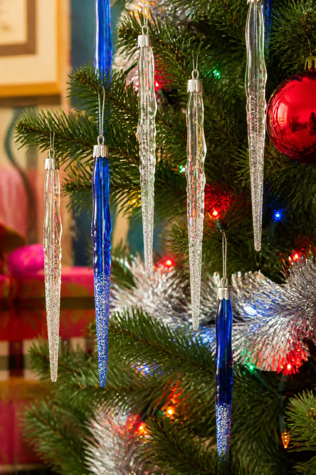 Glitter-Dipped Icicle Ornaments — Icicle ornaments in clear and coloured glass, hung at varying heights, catch multicolour tree lights and scatter tiny