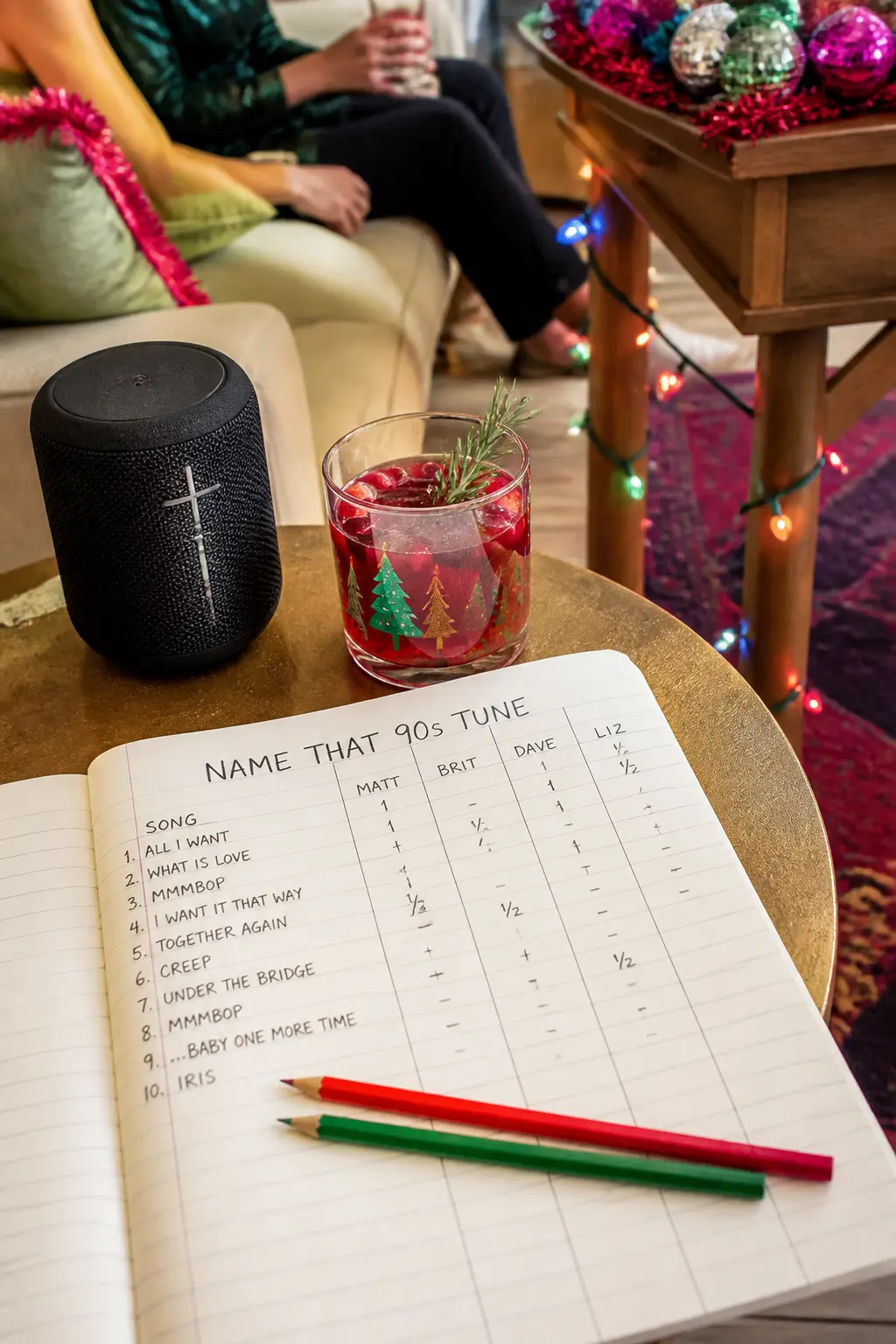 Name That 90s Tune — A Bluetooth speaker running a playlist of 90s Christmas songs with the title hidden, and a pad of paper per team for writing guesses, is a