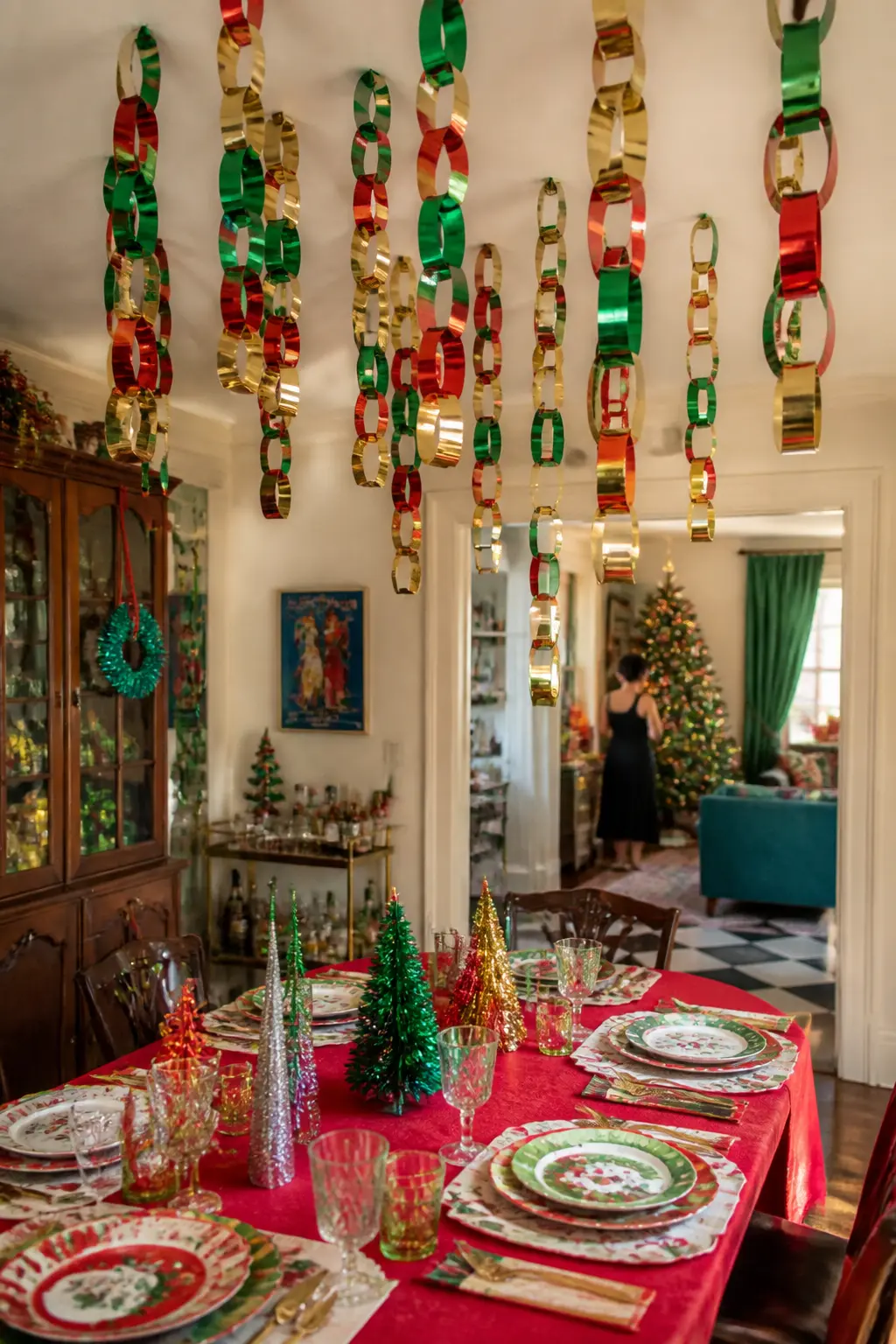 Paper Chain Ceiling Drop — Paper chains hung from a ceiling to a doorframe or window in red, green, and gold foil paper take less than an hour to make and
